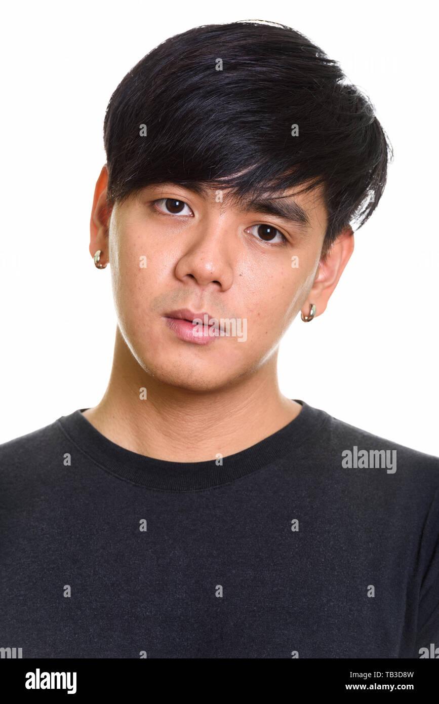 Face of cool handsome Asian man against white background Stock Photo