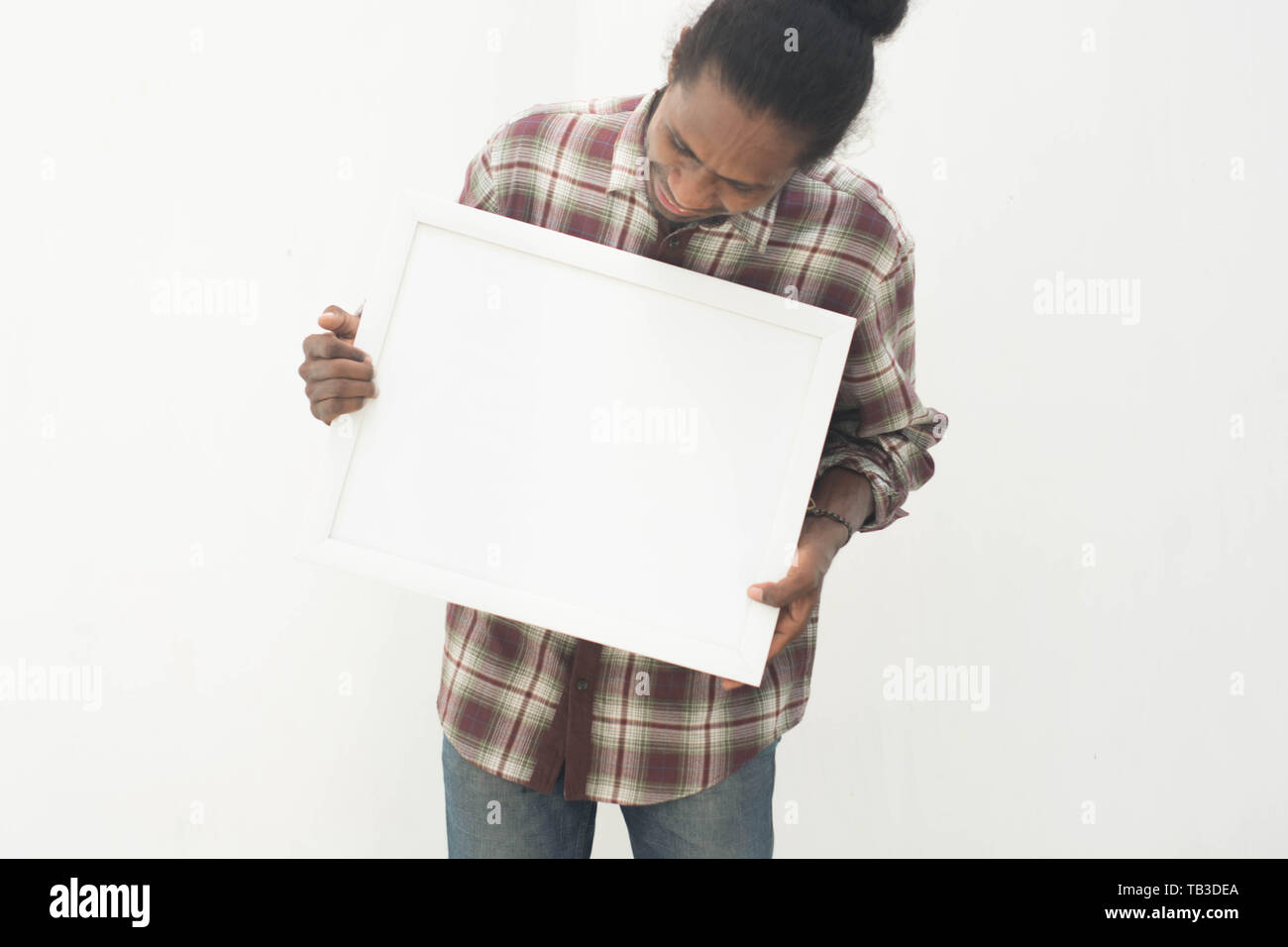 young black man pointing white board with isolated background in white Stock Photo