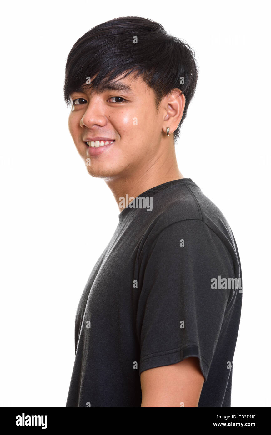 Studio shot of cool happy Asian man smiling Stock Photo