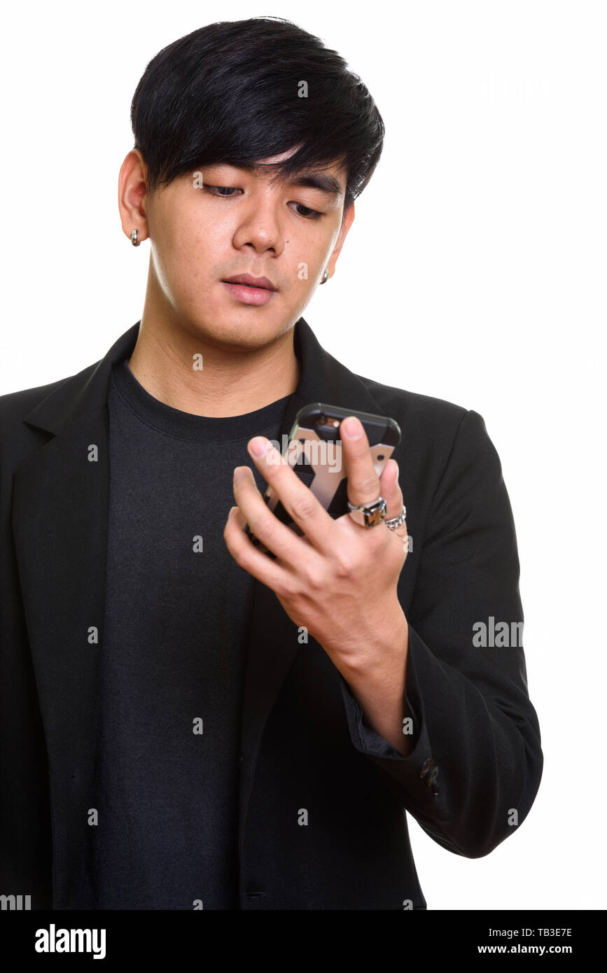 Close up of cool handsome Asian man holding mobile phone Stock Photo