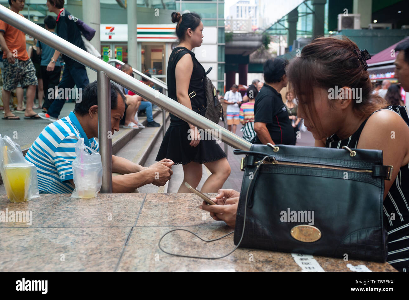 24.02.2019, Singapore, , Singapore - People are cavorting in front of one of the subway trains in Chinatown. 0SL190224D009CAROEX.JPG [MODEL RELEASE: N Stock Photo