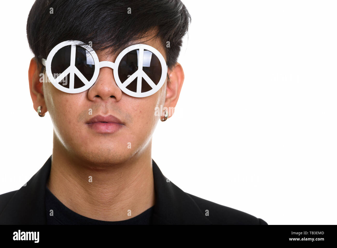 Studio shot of cool handsome Asian man wearing sunglasses with p Stock Photo