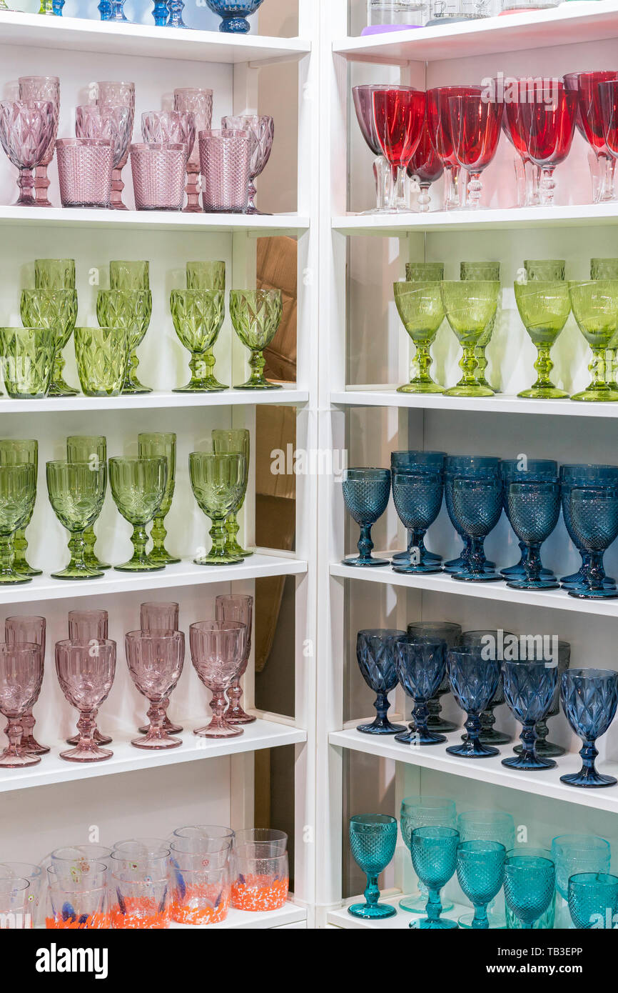 Colorful glasses and vases on the shelf in the souvenir shop. wine