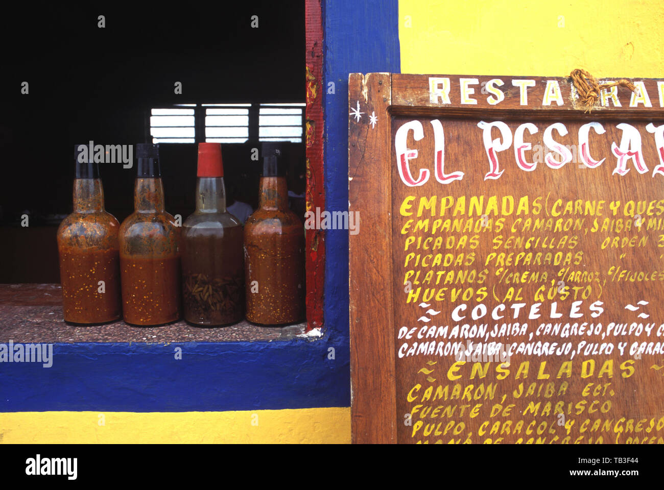 Salsas sit on the windowsill of a seafood restaurant in Tlacotalpan