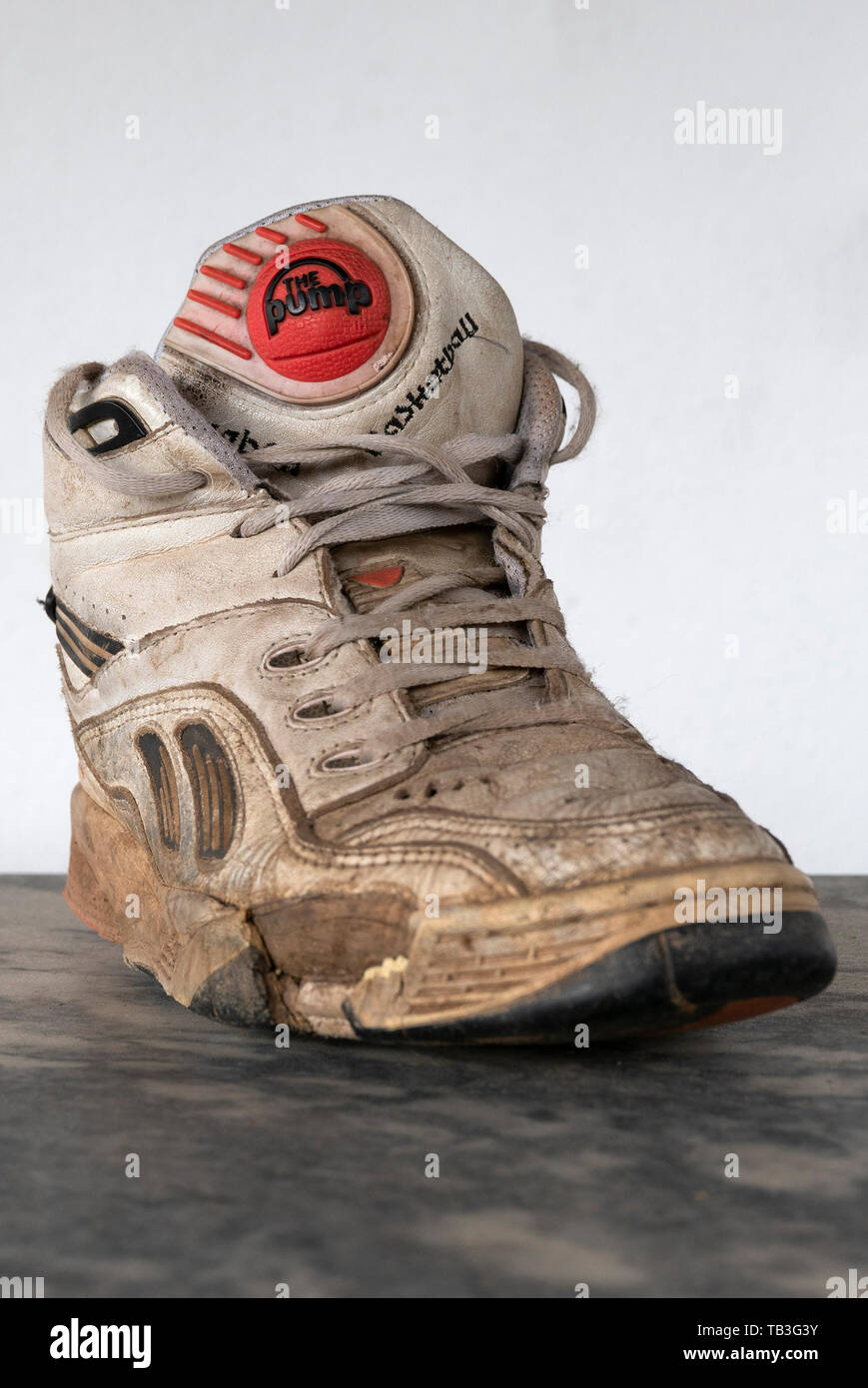 Old worn 1990s Reebok Pump  white basketball sneaker Stock Photo