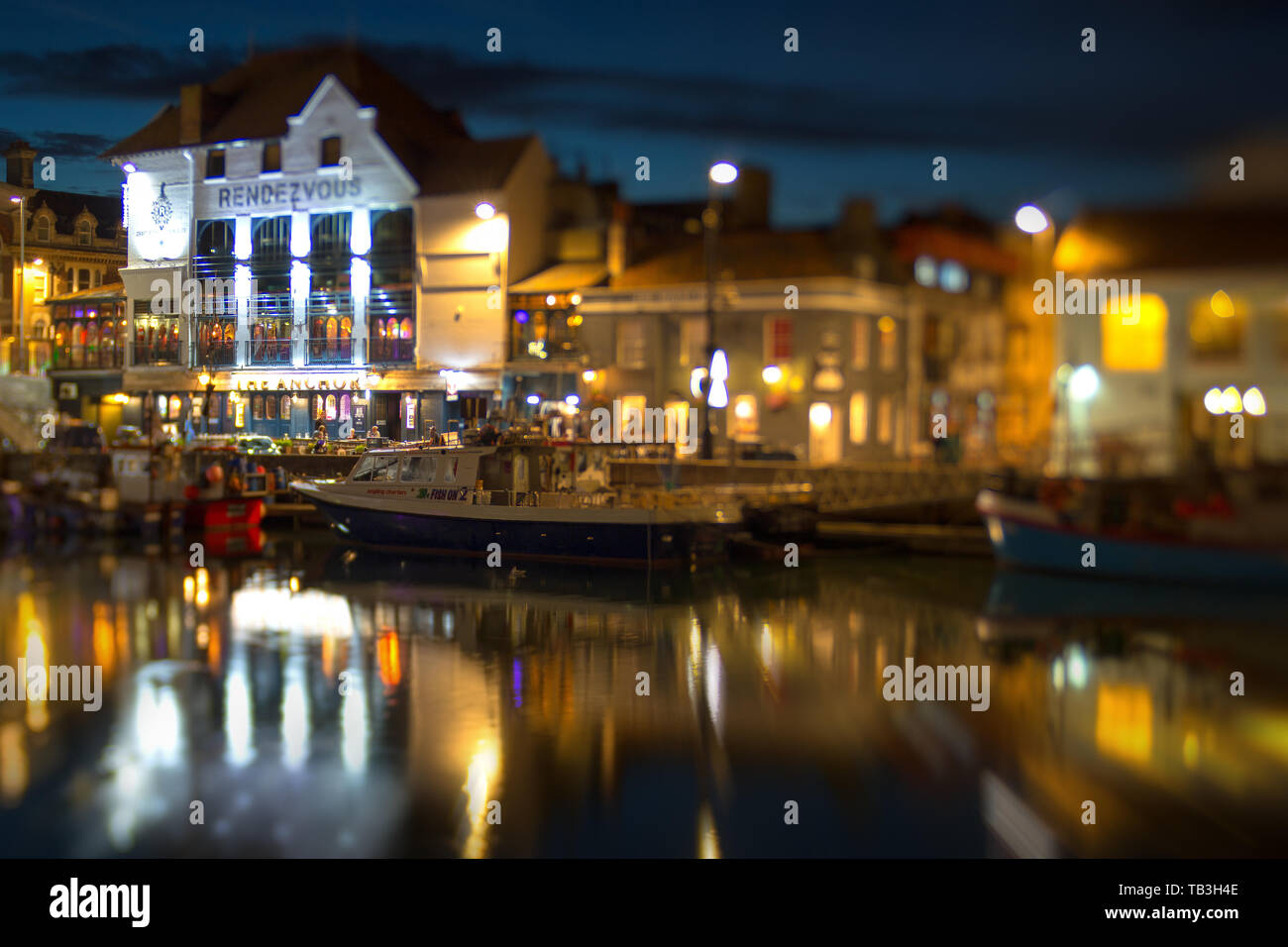 A shot taken at night with a Lensbaby Lens of the Rendevous Nightclub and Harbourside next to the Town Bridge in Weymouth Dorset Stock Photo