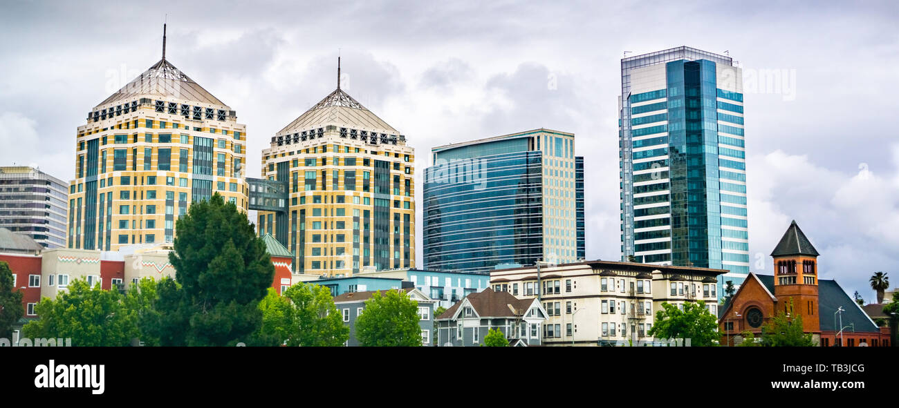 Modern buildings in downtown Oakland rising behind old ones; cloudy spring day; San Francisco bay area, California Stock Photo