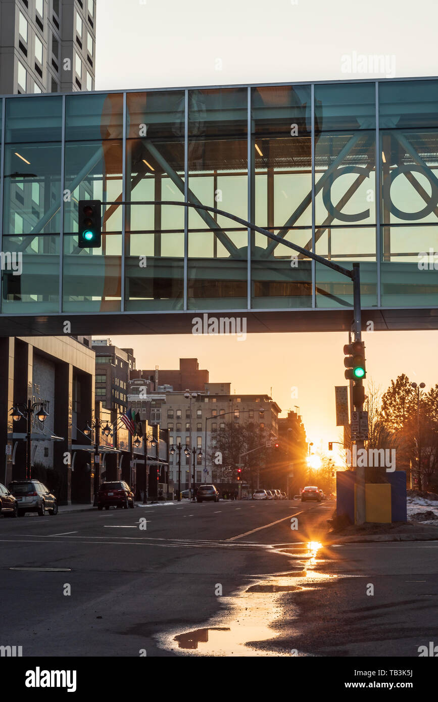 Early Evening Views of the Sun Setting under the Convention Center Skybridge in Downtown Spokane Washington USA Stock Photo