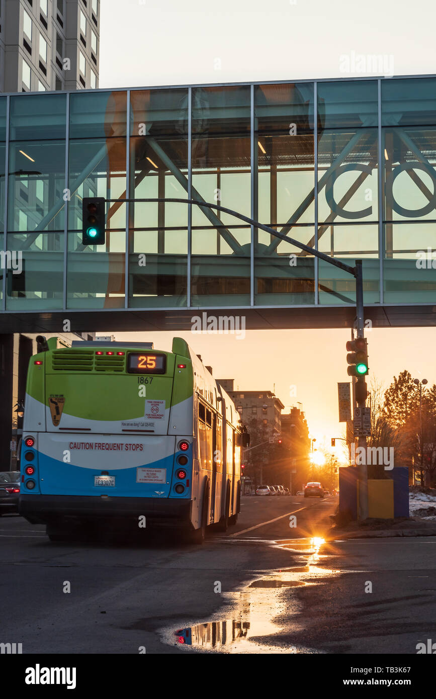 Early Evening Views of the Sun Setting under the Convention Center Skybridge in Downtown Spokane Washington USA Stock Photo