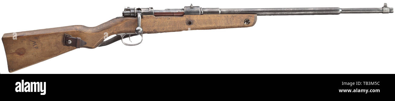 A Volkskarabiner VK 1 (VK 98), code 'bnz 44'(!), Volkssturm, Cal. 8 x 57, no. 7655. Lock not matching-numbered. Partially rough bore, length 52 cm. Muzzle bored to 30 mm length as standard. Five shots. Fixed sights with dovetailed rear sight and welded front sight. Cartridge case marked '44', coded 'bnz' below rear sight. Manufactured by Steyr-Daimler Puch AG, Steyr. Rough overall quality finish. Original bluing with few spots. Rough beech wood stock can be improved by careful cleaning. Original strap. Rare collector's item. Length 103 cm. Erwerb, Additional-Rights-Clearance-Info-Not-Available Stock Photo