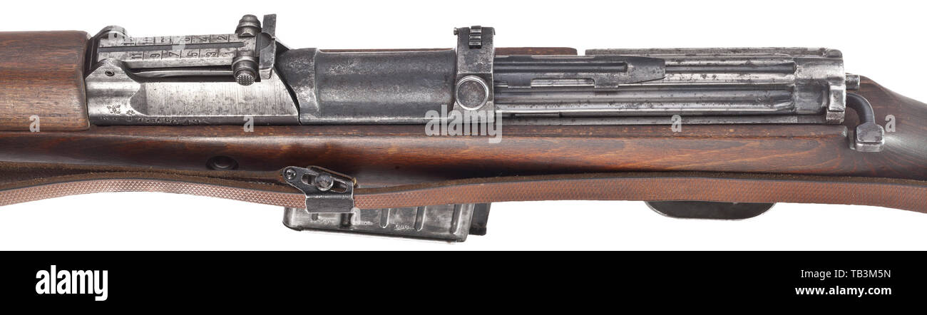A G 43 self-loading rifle, code 'bcd', Undated. Cal. 8 x 57, no. 7584b. Matching numbers. Matt bore. Produced in 1944 by Gustloff-Werk II, Buchenwald. Scope rail. Various WaA acceptance marks. Original finish very spotted, fine pitting at front of barrel. Dark, laminated stock without external S/N, was not taken down for checks. Complete with original strap and cleaning rod. Rare manufacturer, low numbers, untouched and sought-after collector's item. Length 112 cm. Erwerbsscheinpflichtig. ordnance weapon, service weapon, weapons, arms, weapon, ar, Additional-Rights-Clearance-Info-Not-Available Stock Photo