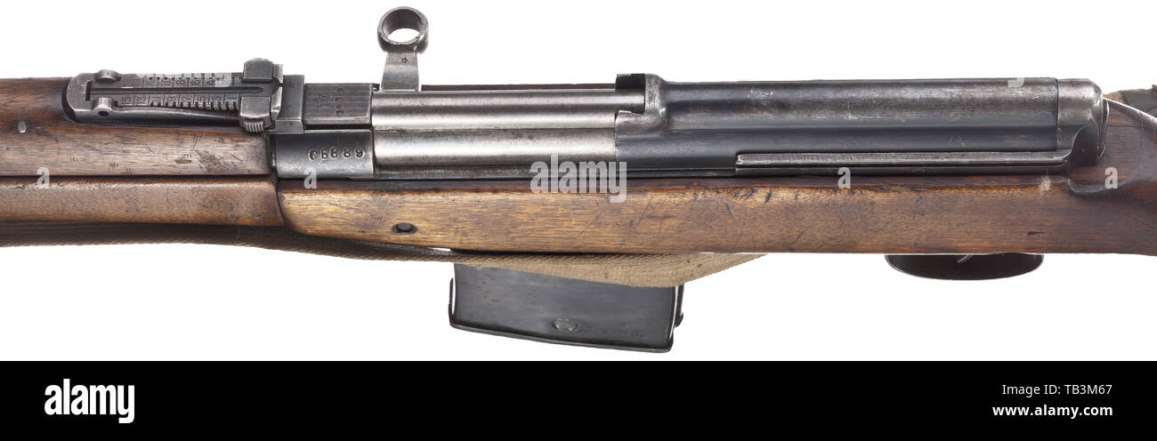 A Tokarev M 38 self-loading rifle (SVT-38), Cal. 7.62 x 54R, no. SB889. Matching numbers except for trigger guard and magazine. Almost bright bore. Produced in 1939. Scope rail. Original finish partially spotted, lock unblued. Two-piece birch wood stock with strong signs of use, small chipping in front of magazine. Complete with magazine, original leather-lined web strap and cleaning rod fixed at the side. Low production numbers. Very rare, untouched collector's item. Length 122 cm. Erwerbsscheinpflichtig. historic, historical 20th century, Additional-Rights-Clearance-Info-Not-Available Stock Photo