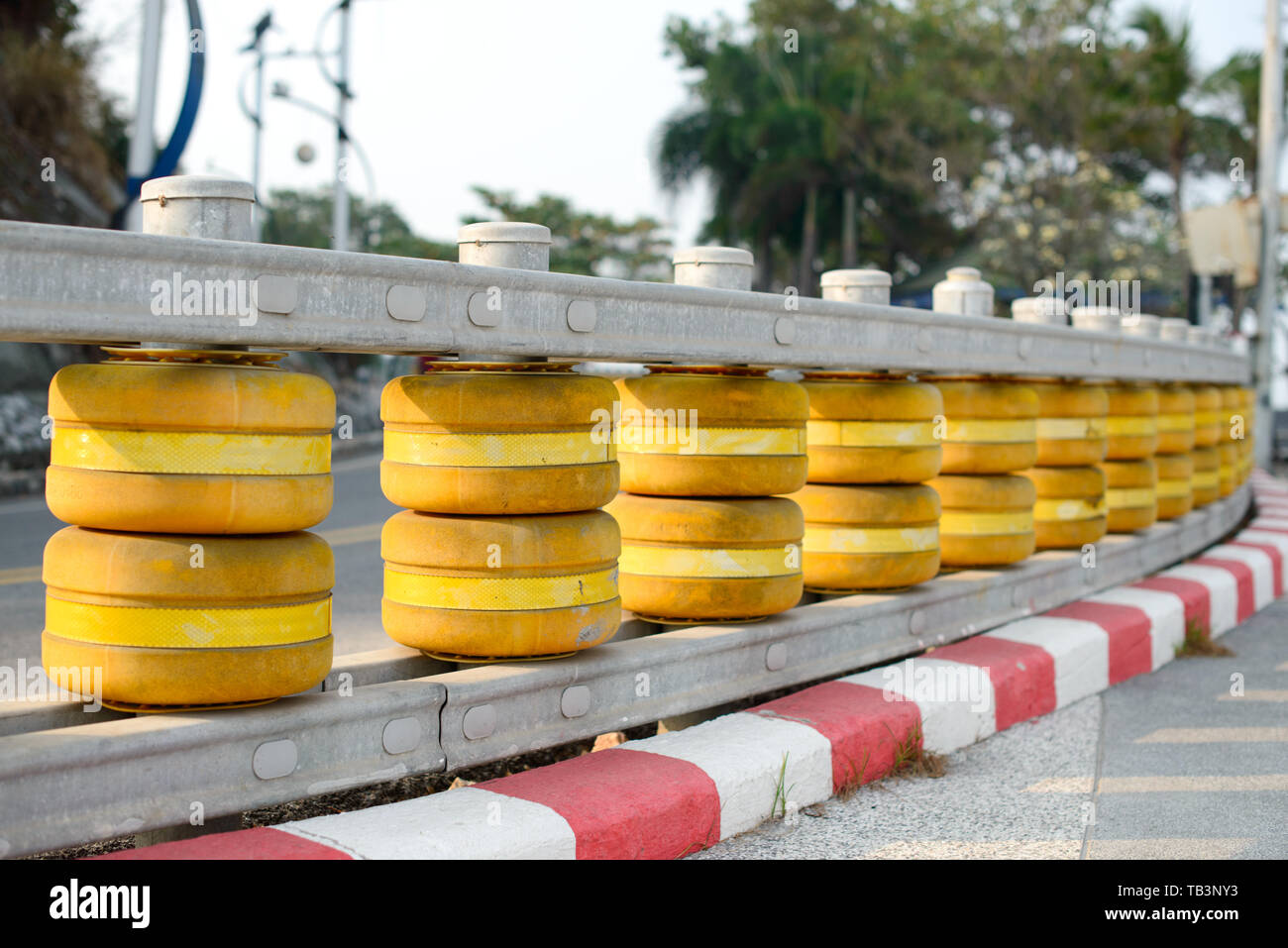 Yellow and red road railing barrier, guard rail on the road. Stock Photo