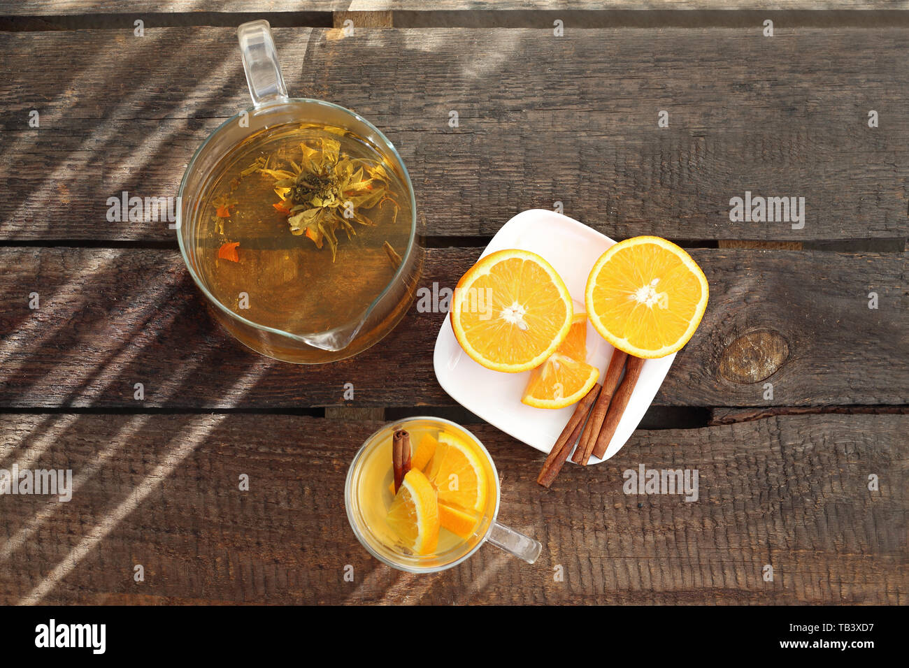 Blossoming green tea with orange, a glass of hot aromatic drink. Stock Photo