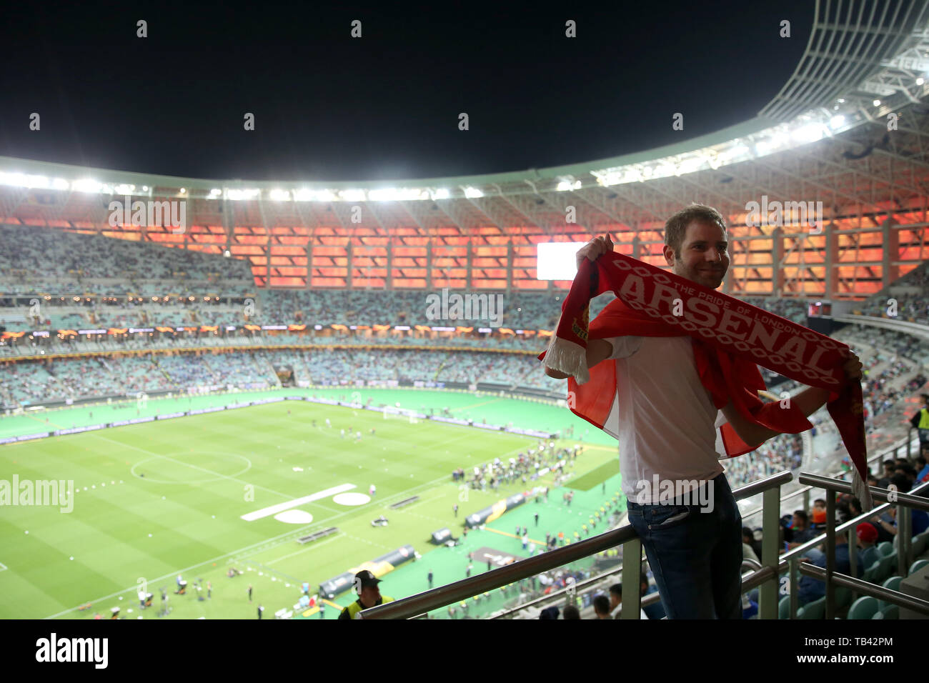 An Arsenal fan holds an Arsenal scarf ahead of the match during the ...