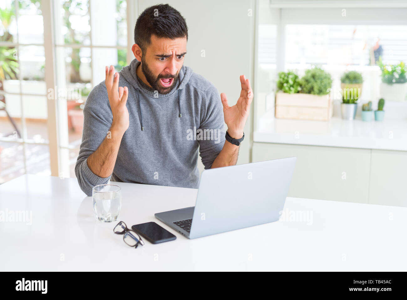 Hispanic Man Using Computer Handsome hispanic man working using computer laptop very happy and ...