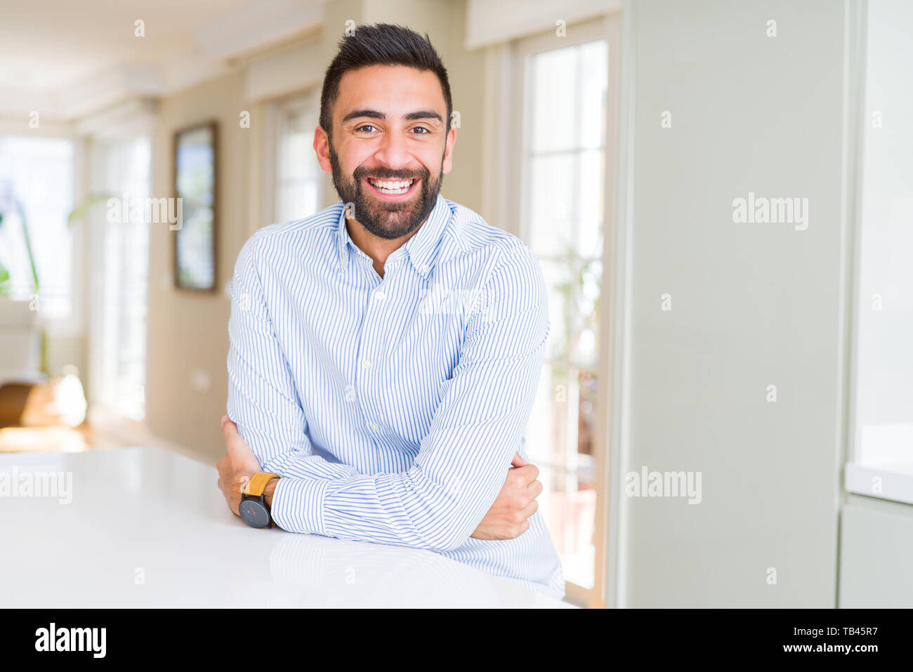 Handsome hispanic business man happy face smiling with crossed arms ...