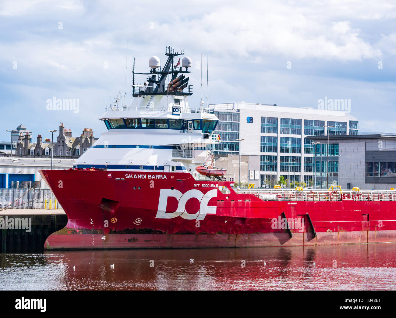 Norwegian DOF Fleet Skandi Barra platform and offshore supply ship docked in Aberdeen harbour, Aberdeen, Scotland, UK Stock Photo