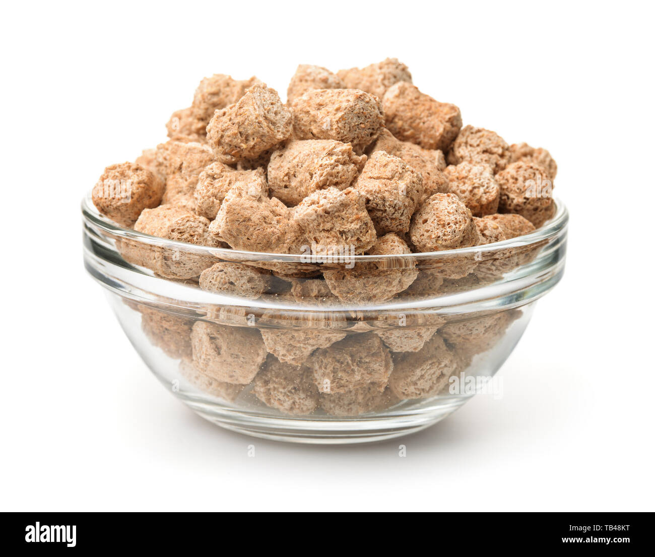 Glass bowl of extruded oats bran pellets isolated on white Stock Photo