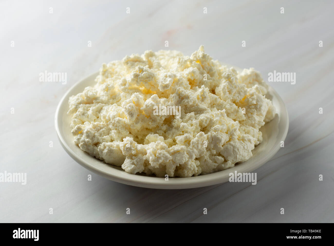 Cottage Cheese Isoalted On Light Marble Background Dairy