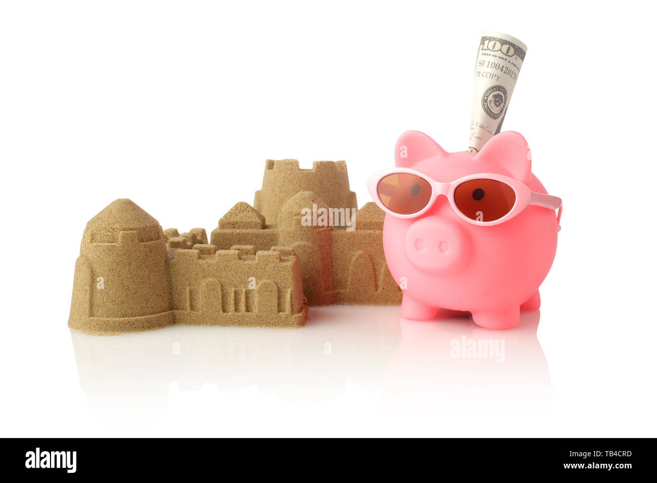 Piggy bank wearing retro sunglasses and sandcastle isolated on white background Stock Photo