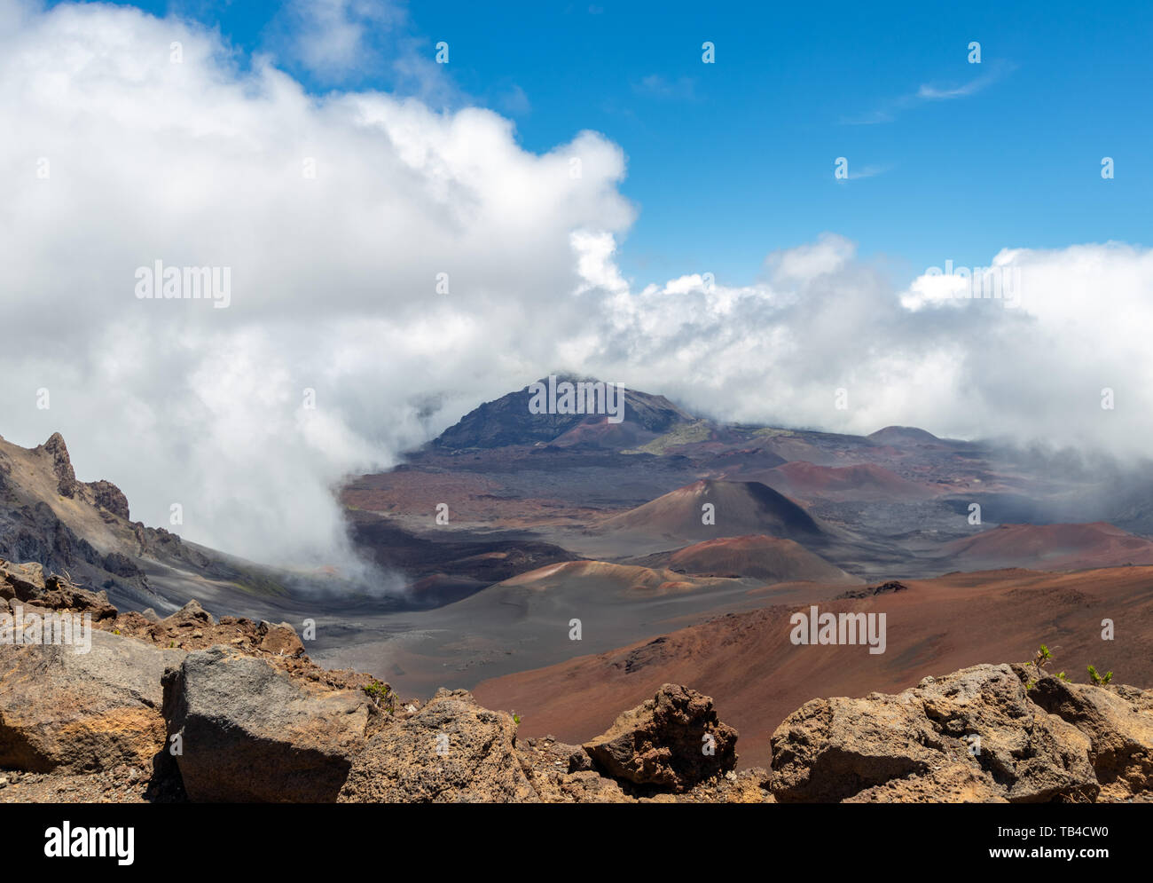 Clouds rolling over beautiful mountains with vivid colors at Haleakala National Park Stock Photo