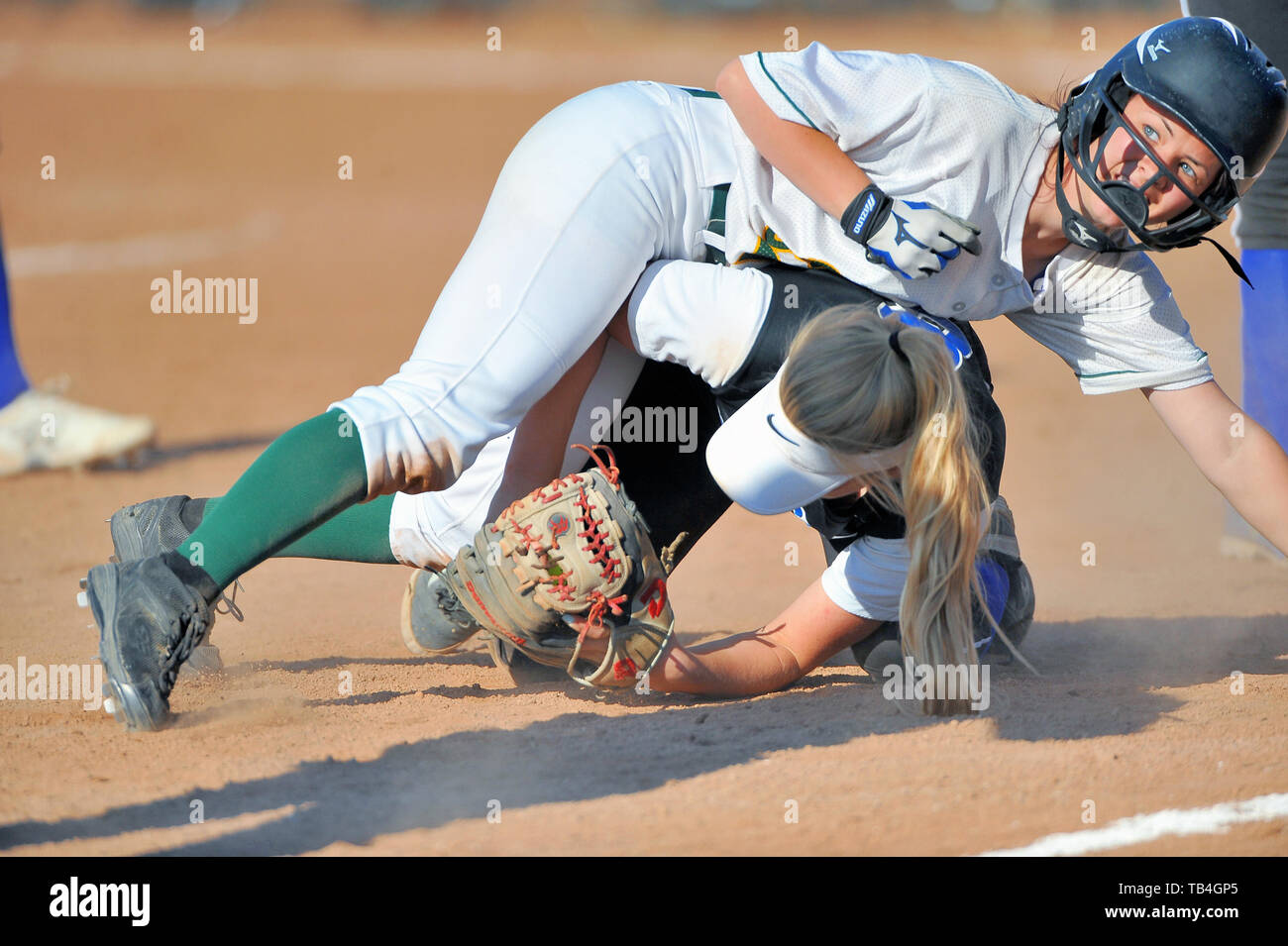 Runner tagged out while making contact with the opposing third baseman. USA Stock Photo