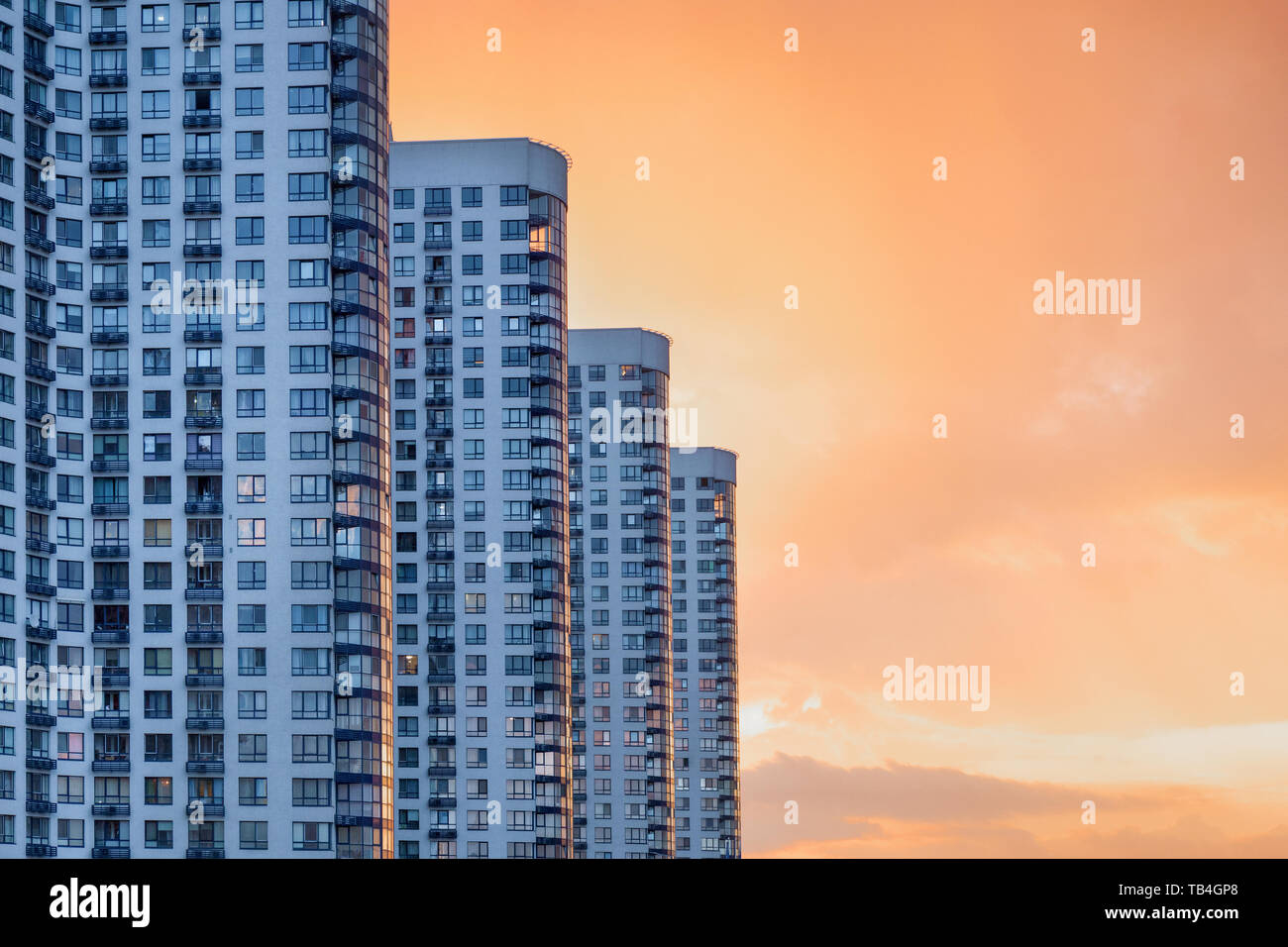 Modern and luxury building with balcony. Apartment building. Skyscrapers at dusk. Urban abstract background, detail of modern glass facade, office Stock Photo