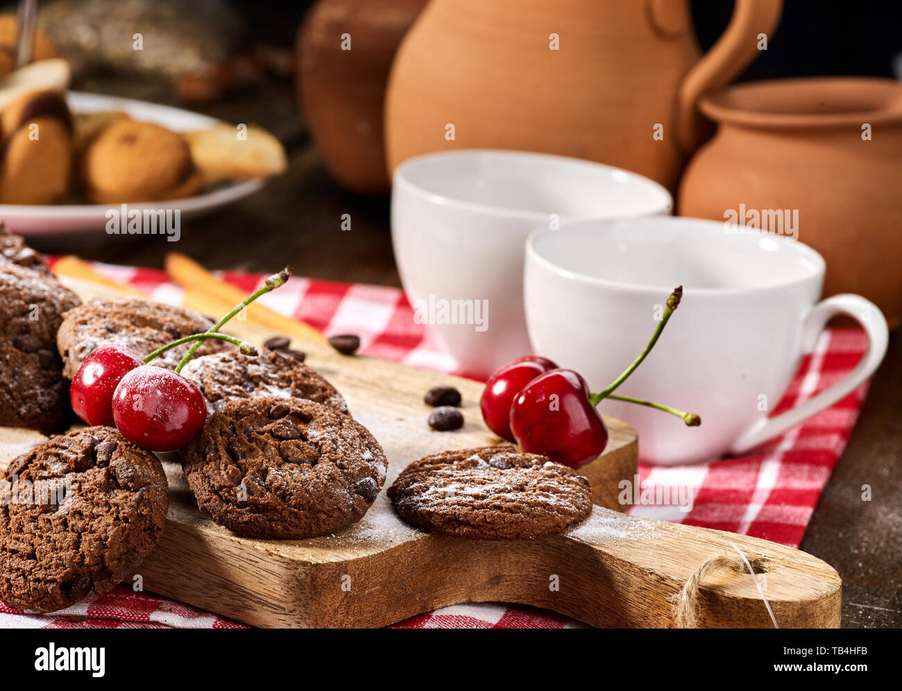 Oatmeal chocolate cookies with coffee grains and cherry. Sun flare Stock Photo