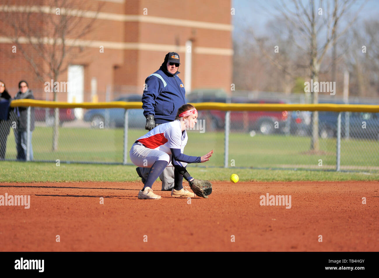Second baseman fielding a ground ball prior to throwing on to first base to retire the batter. USA. Stock Photo