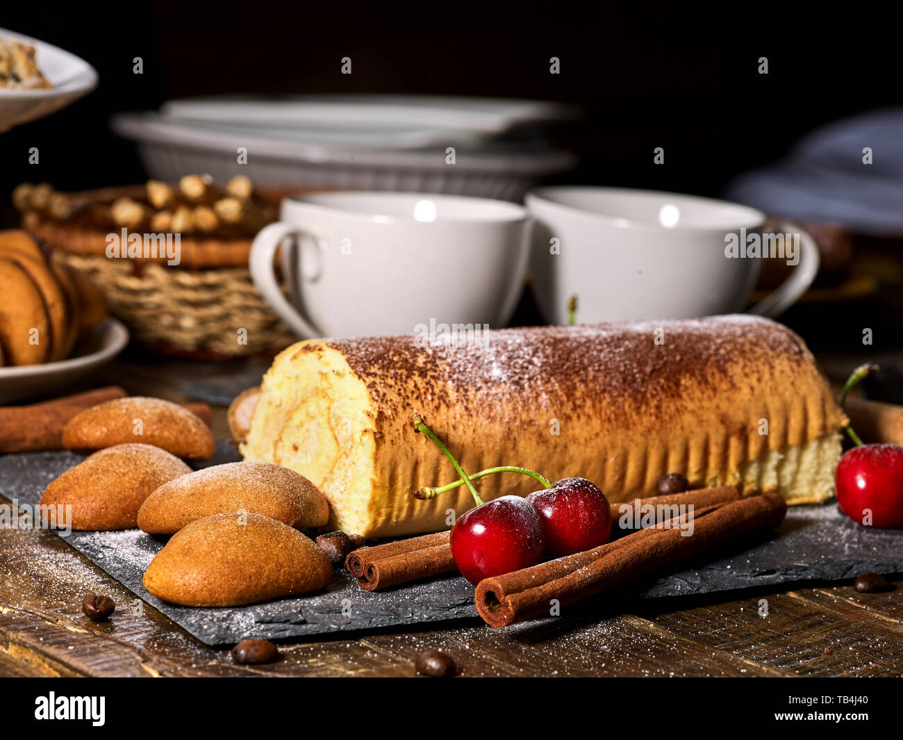 Oatmeal cookies ,rolled cake on tier cake stand with cherry Stock Photo