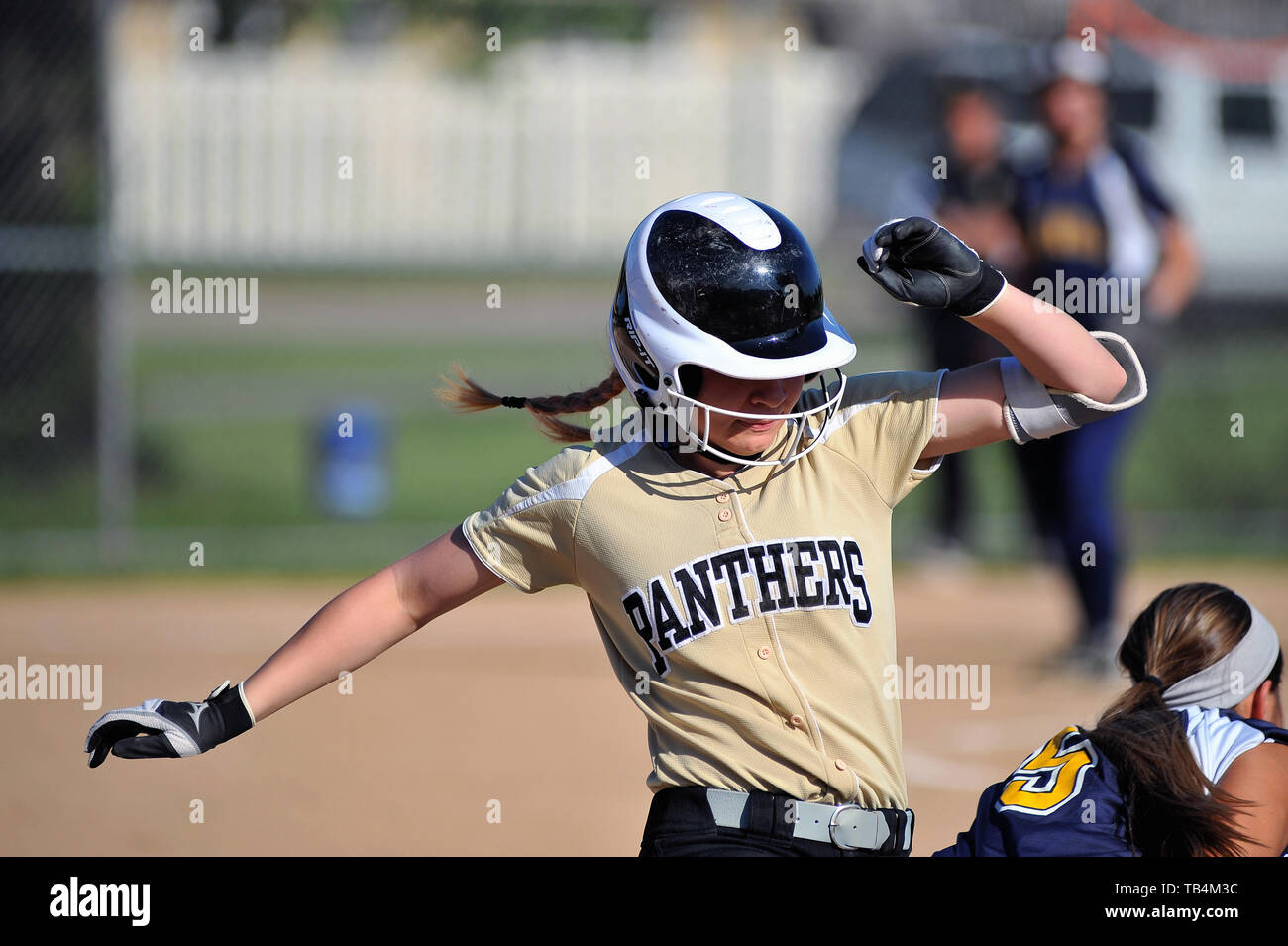 Bater/runner nipped at first base on a close play as the opposing first baseman took the throw to record the out. USA. Stock Photo