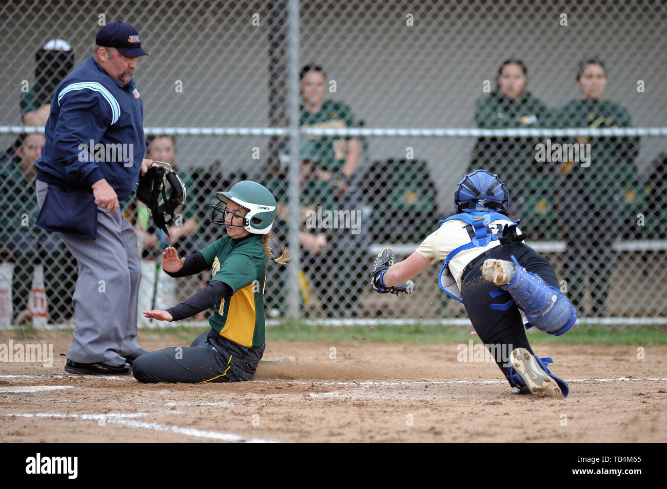 Catcher diving to in an effort to tag a base runner that was attempting