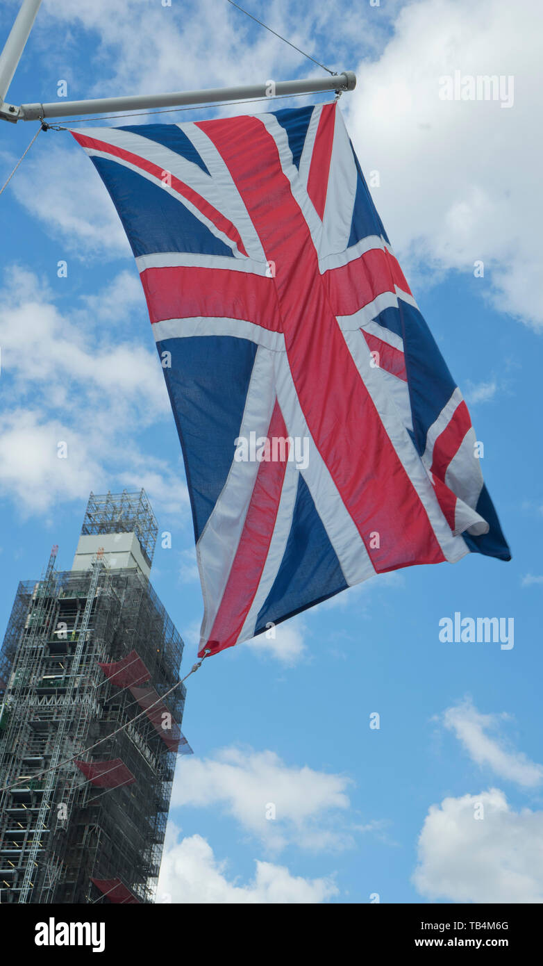 Union Jack flag with Big Ben tower under restoration in Westminster