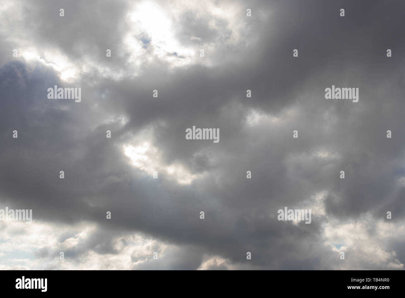 Heavy dark clouds with sunlight highlights and deep shadows Stock Photo