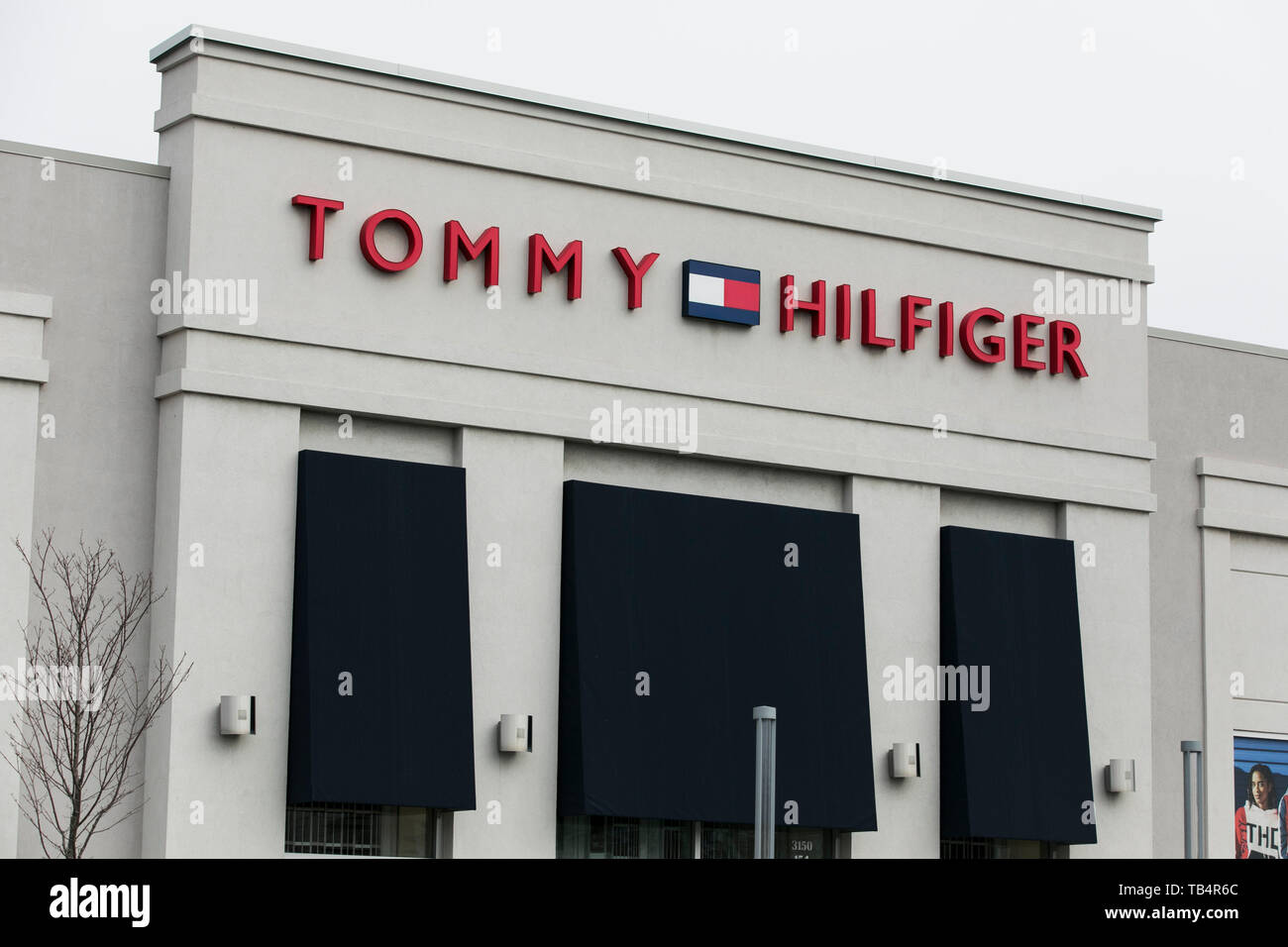 A logo sign outside of a Tommy Hilfiger retail store location in  Vaudreuil-Dorion, Quebec, Canada, on April 21, 2019 Stock Photo - Alamy