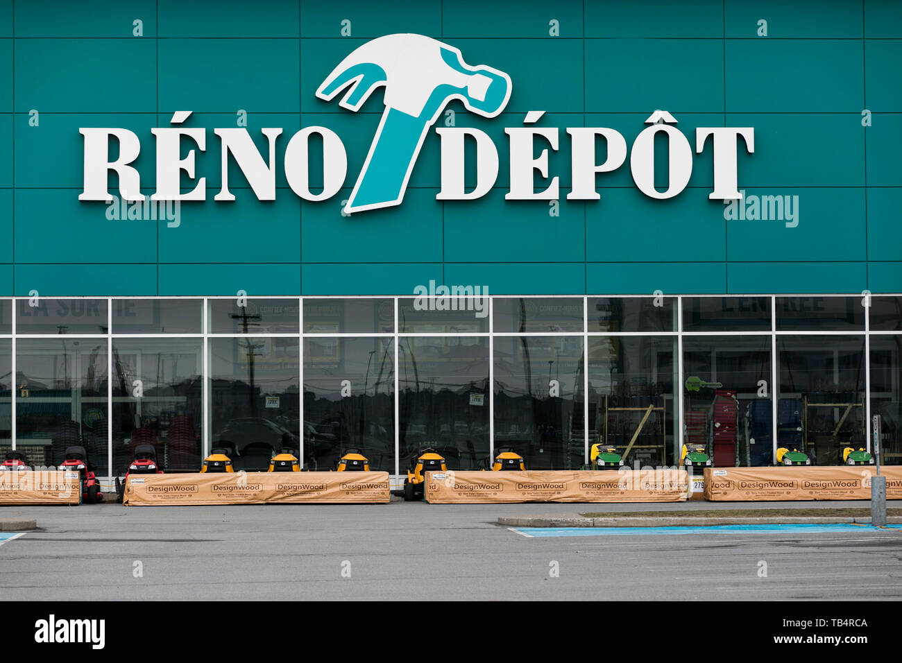 A logo sign outside of a RenoDepot retail store location in Vaudreuil