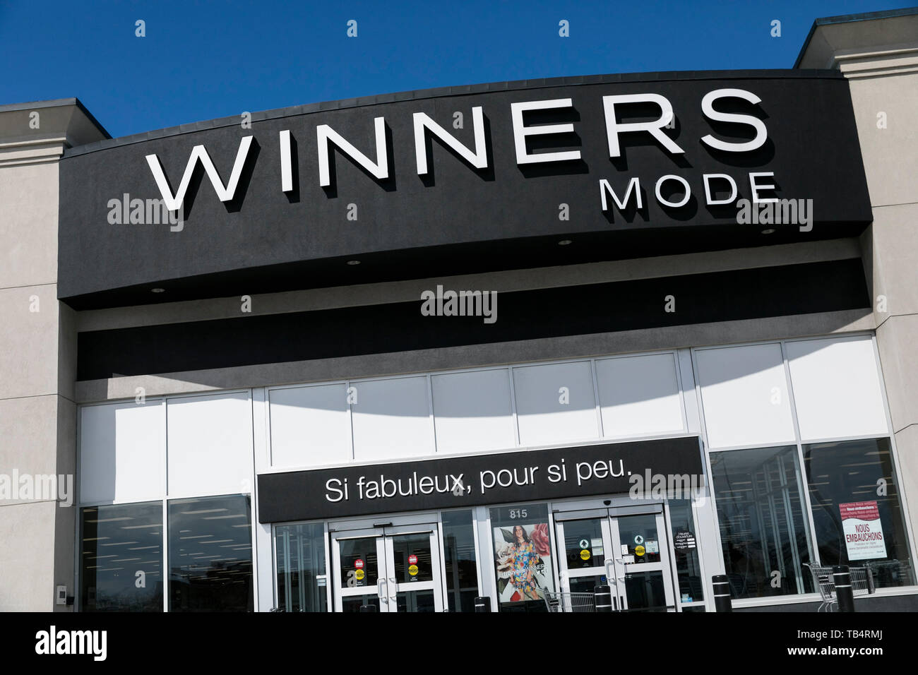 A logo sign outside of a Winners retail store location in Montreal, Quebec, Canada, on April 21, 2019. Stock Photo