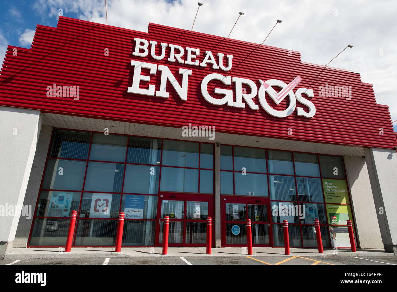 A logo sign outside of a Bureau en Gros (Staples) retail store location in Montreal, Quebec, Canada, on April 21, 2019. Stock Photo