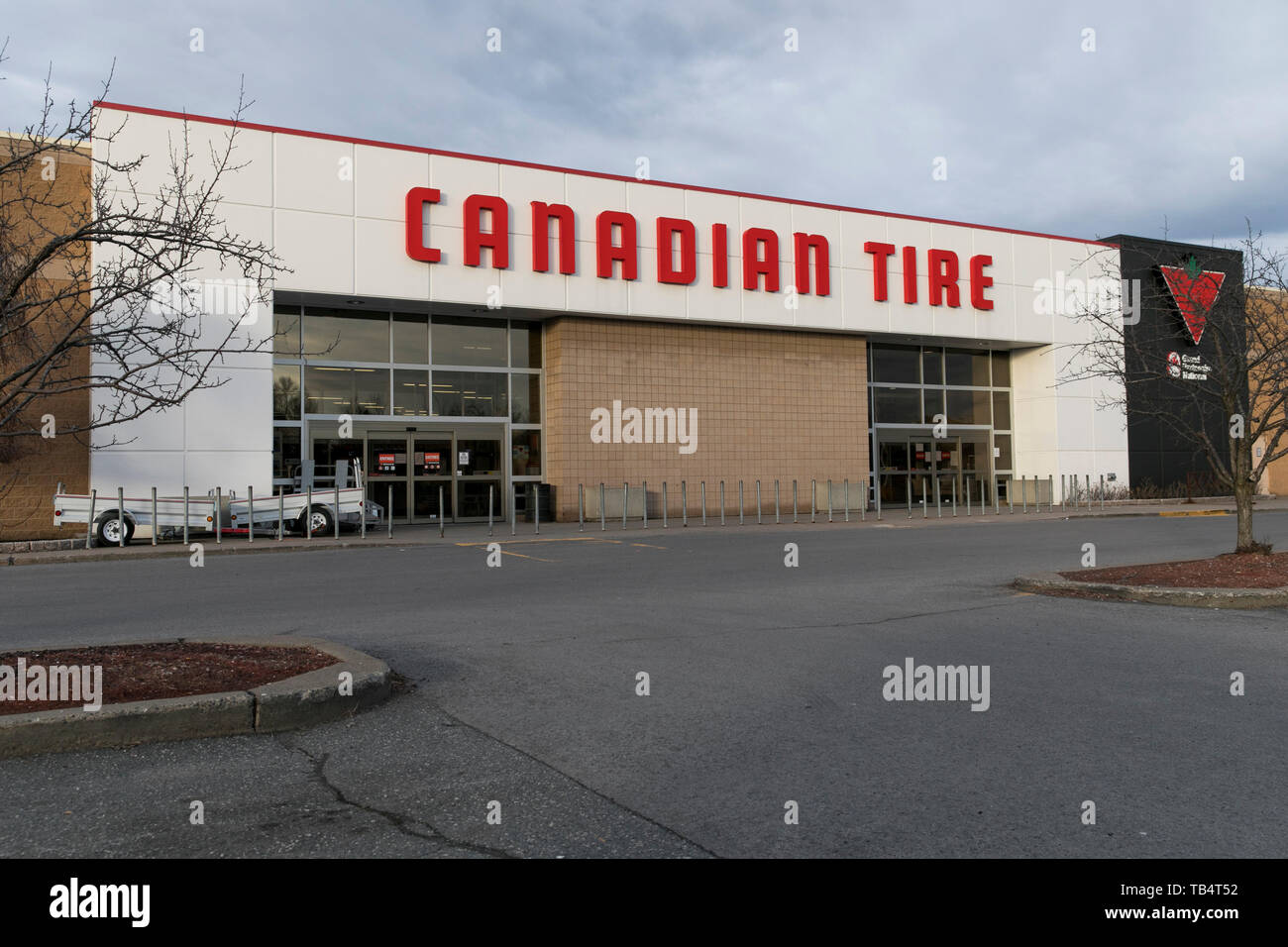 A logo sign outside of a Canadian Tire retail store location in