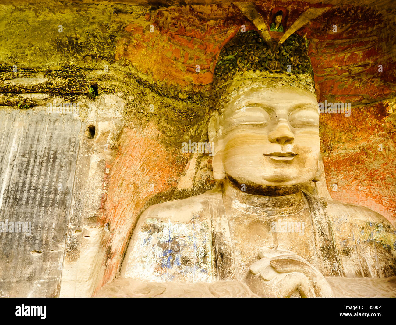 Ancient Stone Hillside Carving of Vairocana (Celestial Buddha) - Baodingshan, Dazu, China Stock Photo
