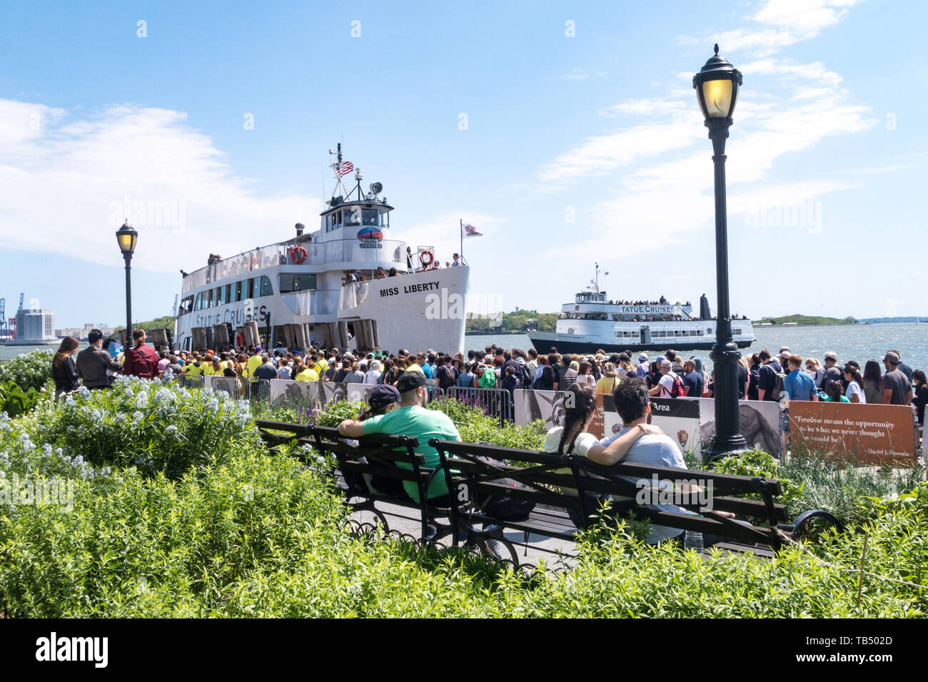 Tourists wait in line to board the Statue of Liberty Ferry in Battery