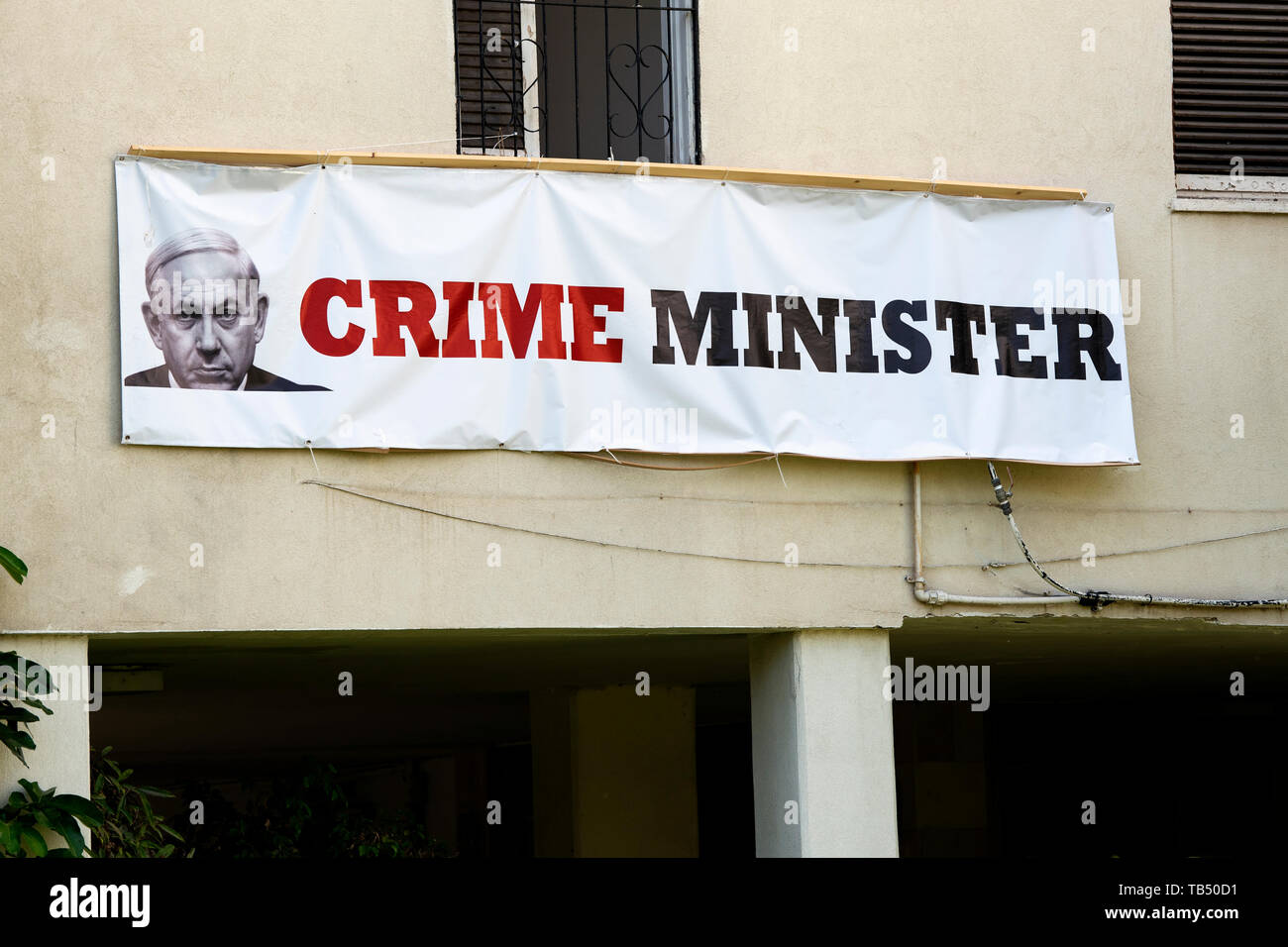 A banner depicting Israeli Prime Minister Benjamin Netanyahu as Crime Minister is seen in Tel Aviv, Israel. Netanyahu is facing fraud and bribery charges. Israel will hold a national election after Prime Minster Benjamin Netanyahu failed to build a coalition government with former Defense Minister, Avigdor Lieberman. Stock Photo