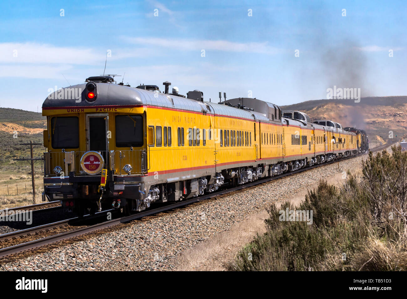 Union Pacific historical passenger cars trail behind the steam power of UP 844 and UP 4014 as they approach Evanston, Wyoming. Stock Photo