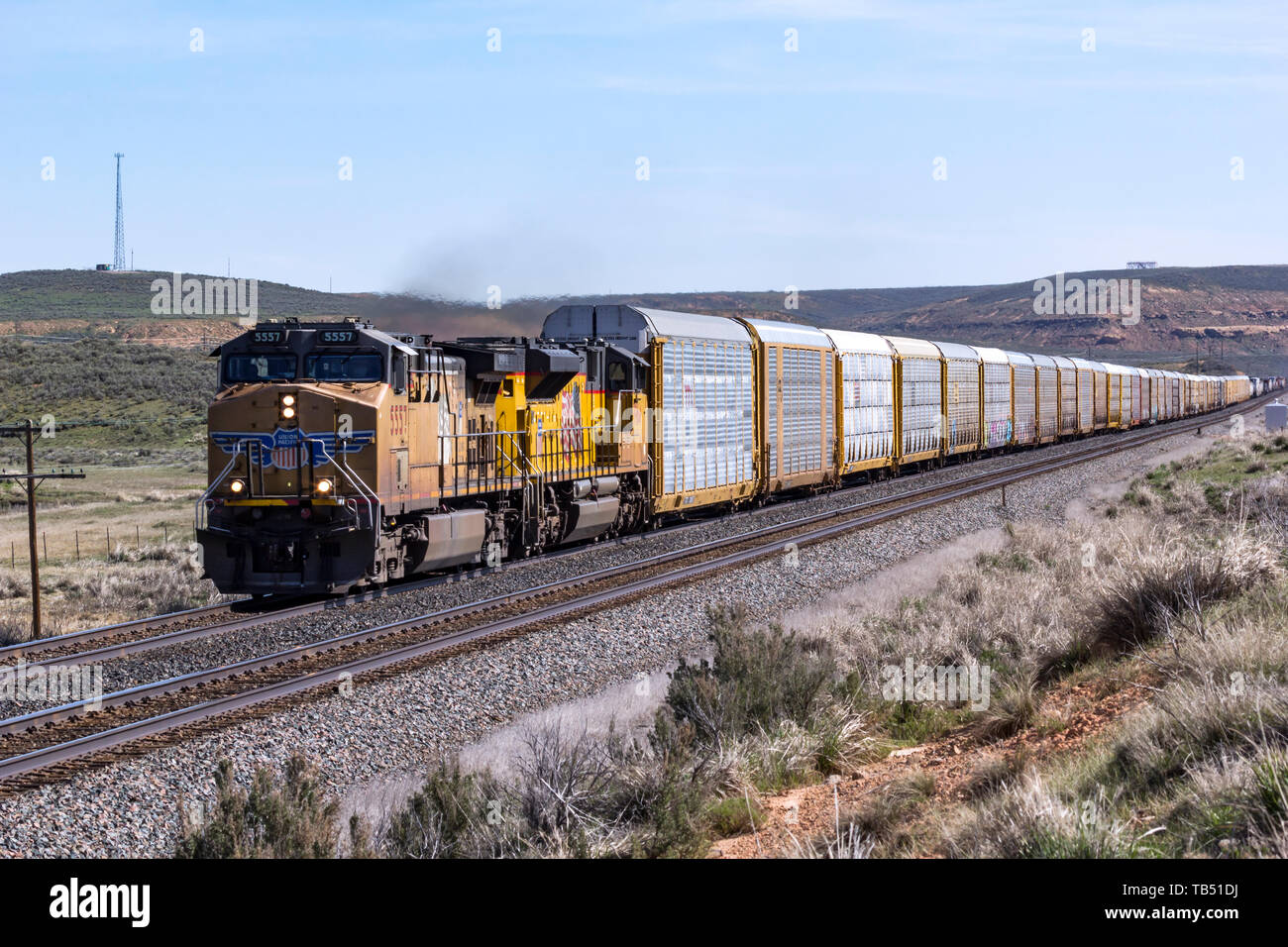 Union Pacific 5557, a model GP50, pulls a train of auto transports west out of Evanston, Wyoming, towards Utah. Stock Photo
