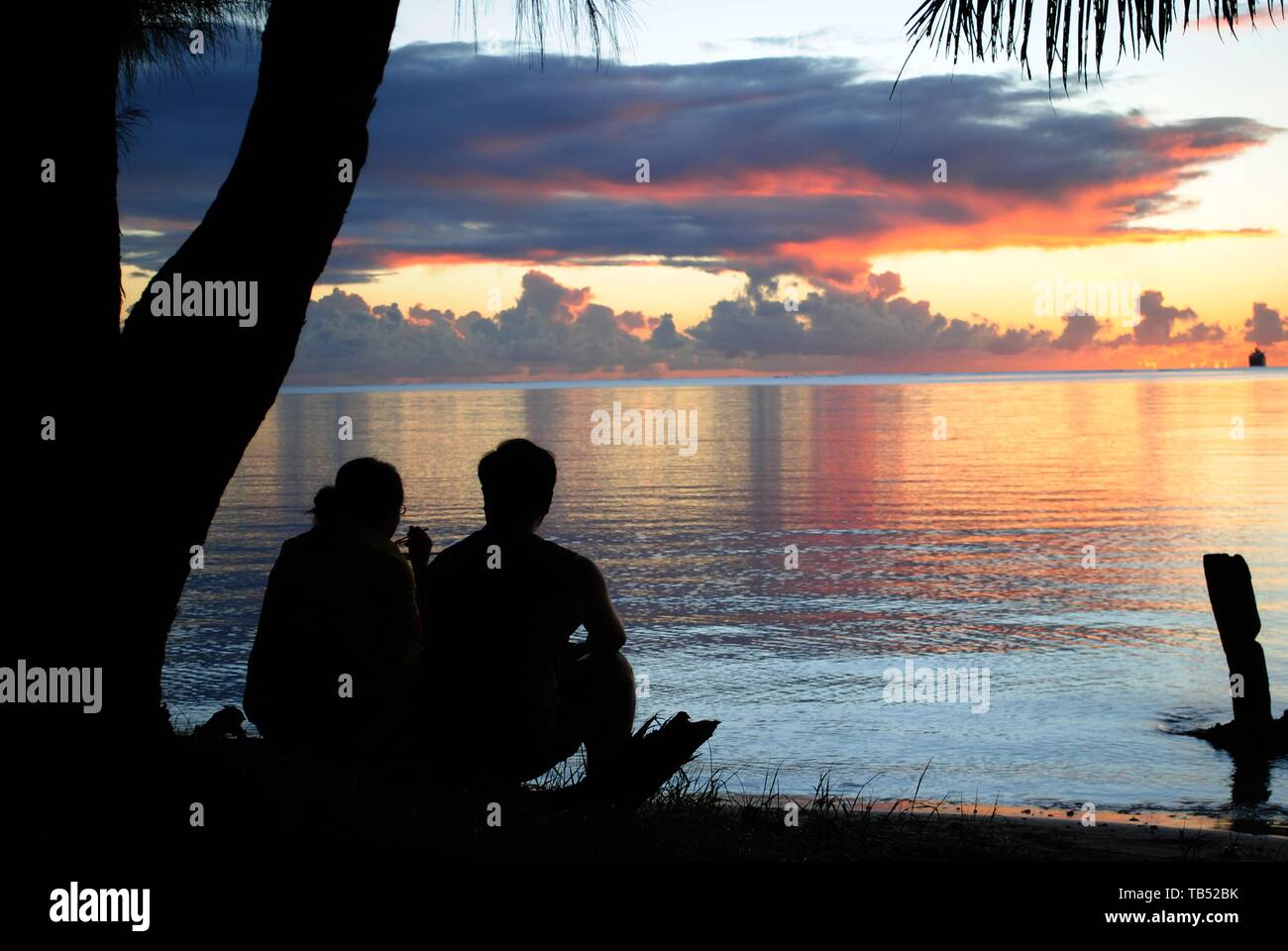 Silhouette of an unrecognizable couple enjoying the sunset from the ...