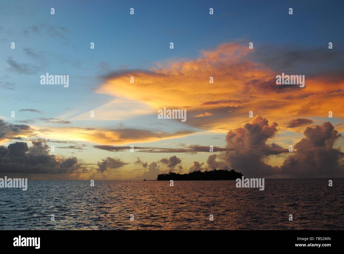 Gorgeous clouds over the silhouette of Managaha Island, Saipan at sunset Stock Photo