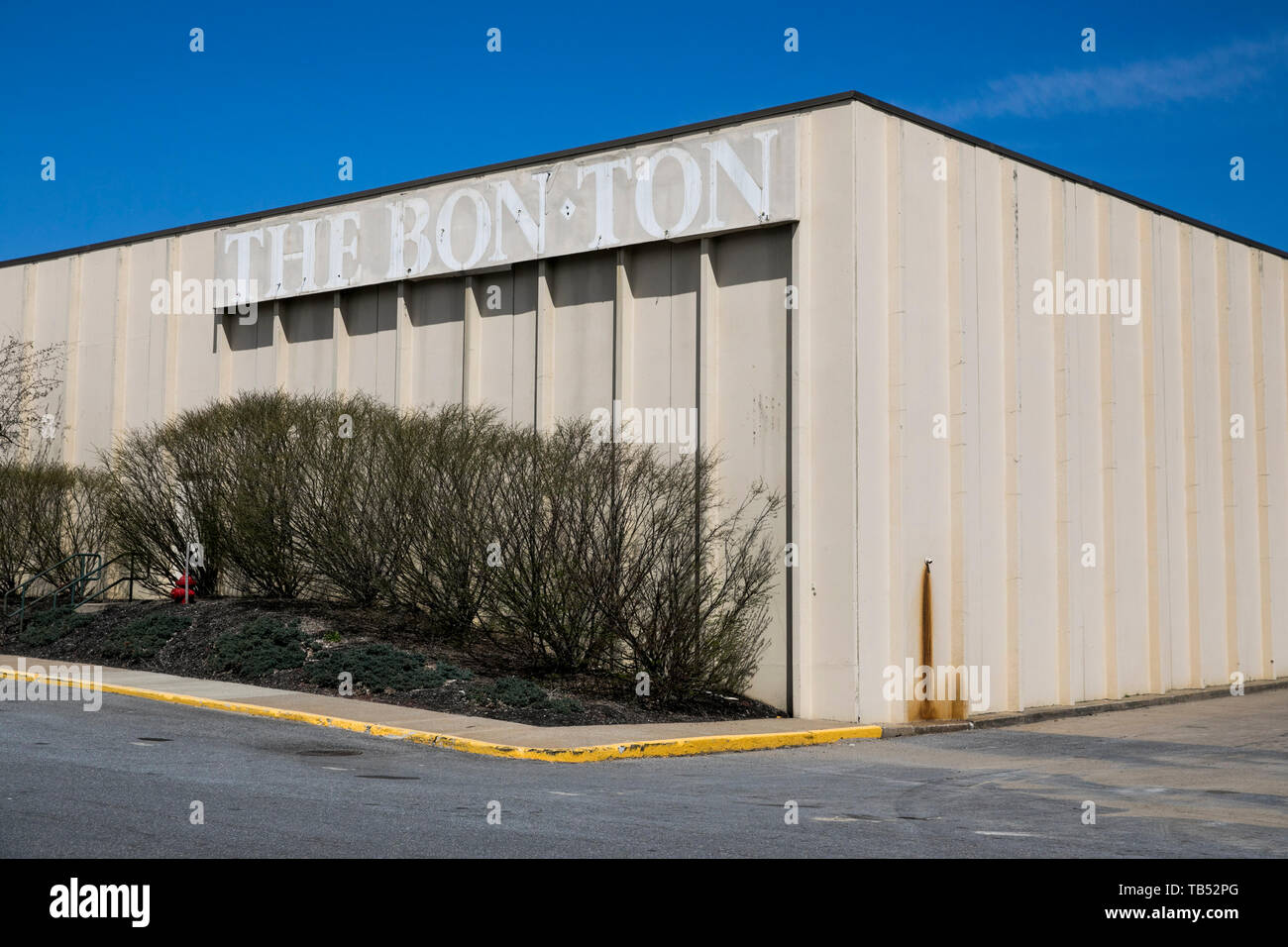 The outline of a The BonTon logo sign outside of a closed retail store