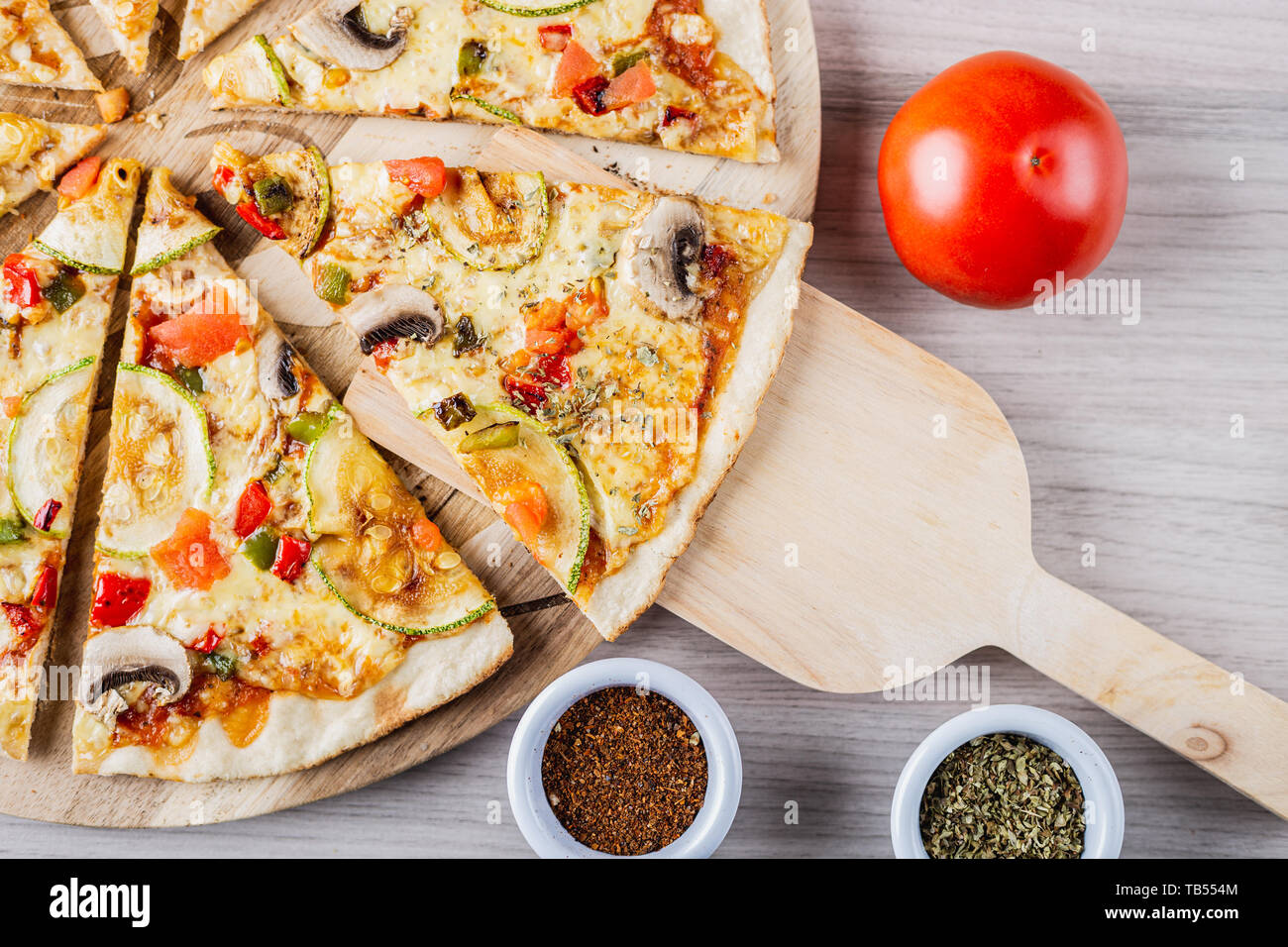 Zucchini vegan pizza with tomato, oregano and merken Stock Photo