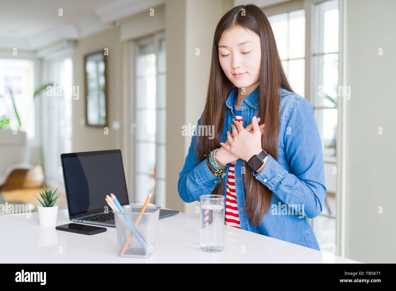 Beautiful Asian woman working using computer laptop smiling with hands ...